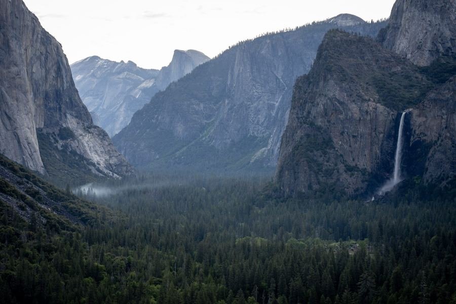 Morning fog drifting through Yosemite Valley with Bridalveil Fall