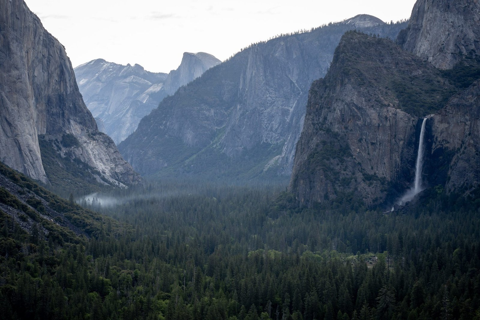 Morning fog drifting through Yosemite Valley with Bridalveil Fall